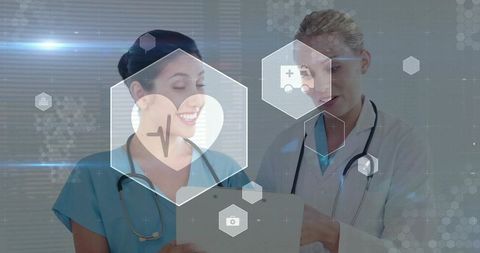 Two female medics reviewing digital patient data on tablet with holo healthcare icons