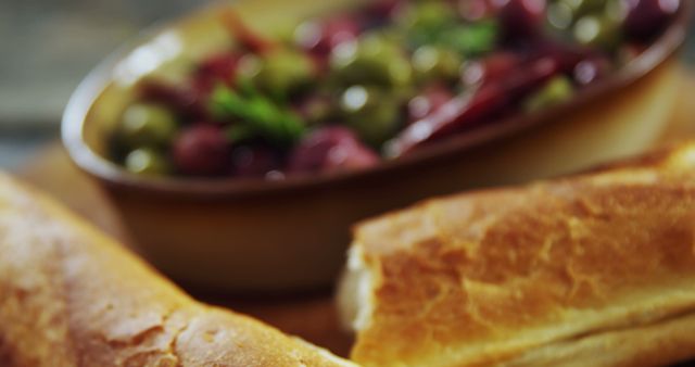 Close-Up of Fresh Baguettes with Olive Appetizer in Background - Download Free Stock Images Pikwizard.com