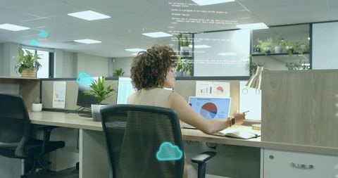 Data analyst reviewing charts on dual monitors in modern office