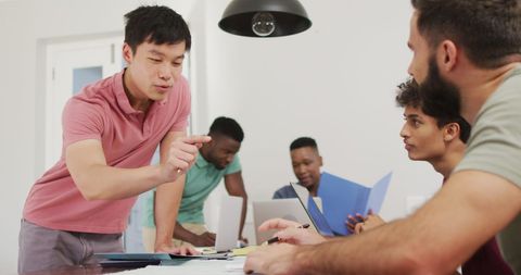 Diverse Group of Men Collaborating in Modern Apartment