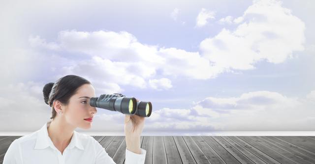 Businesswoman stands on wooden deck using binoculars, looking towards a cloudy sky. This image can be used to represent concepts of future planning, vision, strategic thinking, and forward-looking objectives. Ideal for business promotional materials or motivational content.