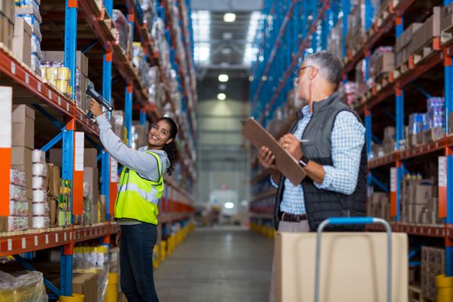 Warehouse manager and female worker interacting while working in warehouse