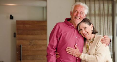 Senior Couple Hugging at Home Showing Warm Affection