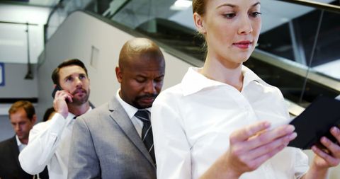 Business travelers waiting at airport check-in counter