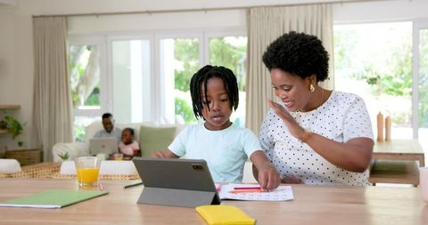Mother Assisting Son with Homework at Home