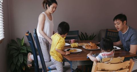 Asian Family Enjoying Breakfast Together at Home