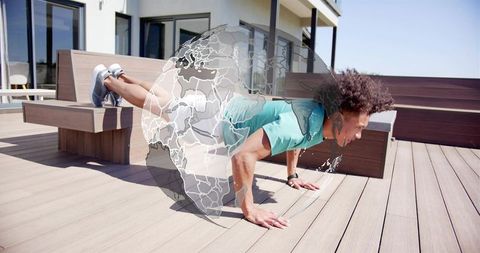 Athlete holding elevated plank on sunlit rooftop bench with translucent globe overlay