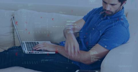 Reclining man typing on laptop with code overlays for remote work, coding and cybersecurity