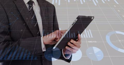 Businessman Swiping Tablet with Dashboards and Charts for Financial Data Visualization