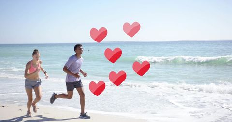 Diverse Couple Jogging on Beach with Digital Heart Overlay