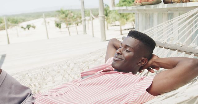 Relaxed Young Man Enjoying a Beach Hammock in Sunshine - Download Free Stock Images Pikwizard.com