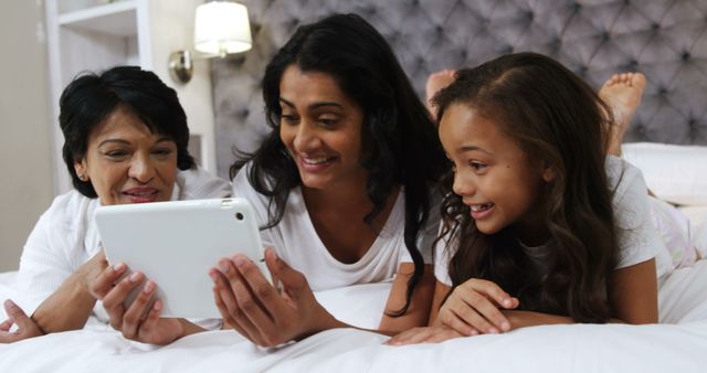 Multi-Generational Family Using Tablet on Bed - Download Free Stock Images Pikwizard.com