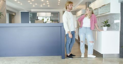 Happy Couple Touring Modern Kitchen, Discussing New Home Interiors