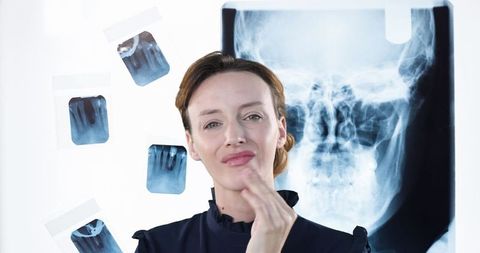 Dentist Examining X-Rays for Precise Diagnosis Planning