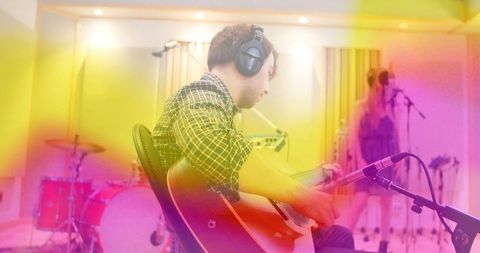 Guitarist Recording in Modern Studio with Virtual Vocals