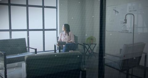 Asian Woman Contemplating in Modern Office Lounge with Tablet