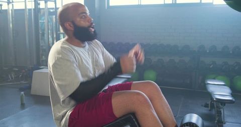 African american man performing decline bench crunches in gym for core strength training