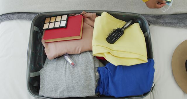 Perfect for use in articles or advertisements related to travel planning, packing tips, vacation preparation, and organizing personal belongings. Illustrates a convenient and organized packing approach.