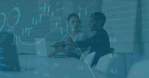 Diverse coworkers analyzing financial data across office table