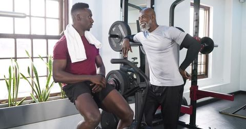 Trainer Encouraging Trainee During Gym Workout for Fitness Motivation