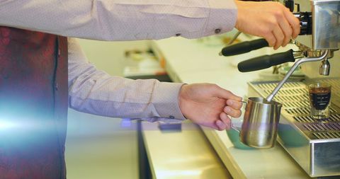 Barista Skillfully Preparing Espresso Shot in Modern Cafe