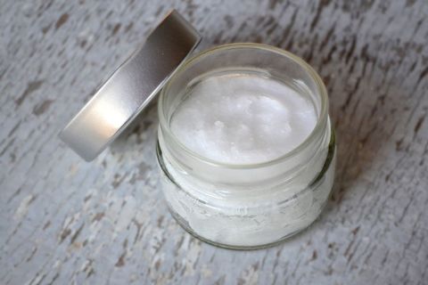 Jar of Moisturizing Coconut Oil on Textured Surface