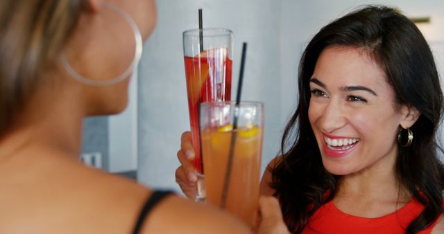 Two Women Enjoying Refreshing Cocktails and Toasting Cheerfully - Download Free Stock Images Pikwizard.com