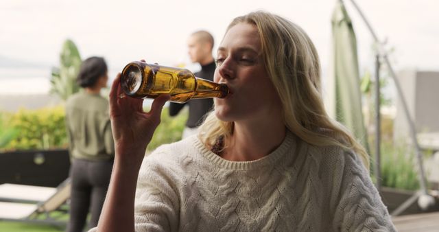Woman Drinking Beer Outdoors in Casual Social Gathering - Download Free Stock Images Pikwizard.com