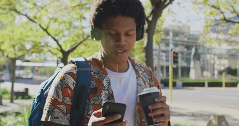 Modern Urban Commuter Using Smartphone with Coffee