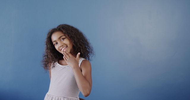 Playful Mixed-Race Girl Against Blue Wall Background - Download Free Stock Images Pikwizard.com