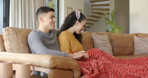 Happy Couple Relaxing Together on Cozy Leather Couch