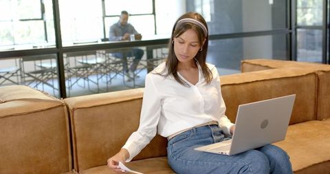 Businesswoman Analyzing Document in Modern Office Lounge - Download Free Stock Images Pikwizard.com
