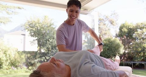 Physiotherapist guiding senior woman in outdoor therapy session