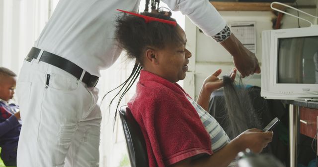 Woman Getting Braided Hairstyle at Salon Using Mobile Device - Download Free Stock Images Pikwizard.com