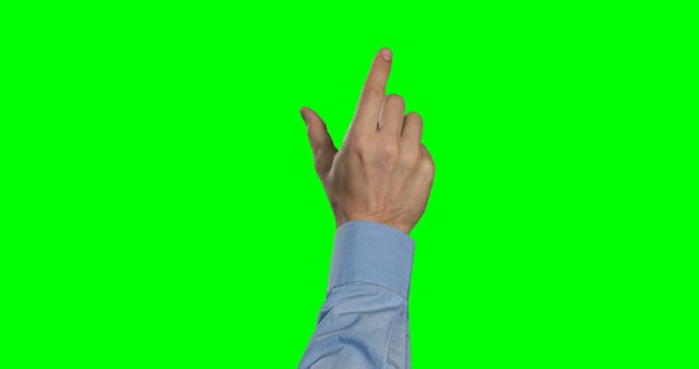A Caucasian hand is making a crossing fingers gesture against a green screen background, with copy space. Crossing fingers is commonly used to wish for luck or to indicate a promise or hope.