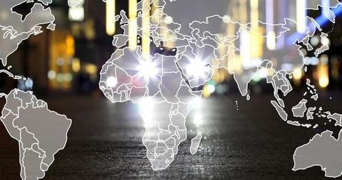 Global map overlay reflecting on wet urban street at night with headlights and lens flare