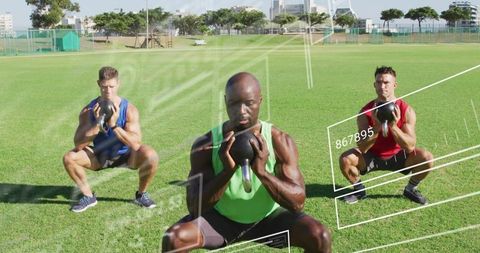 Three male athletes holding kettlebells performing goblet squats on green field with fitness overlay