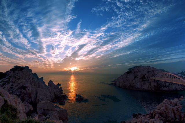 Stunning Coastal Sunrise Over Rocky Cliffs and Calm Sea - Download Free Stock Photos Pikwizard.com