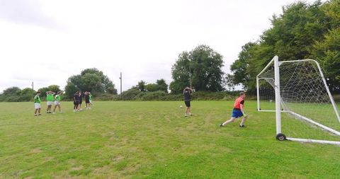 Teenage boys playing soccer encouraging team spirit