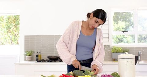 Woman Preparing Fresh Vegetables at Modern Kitchen Island