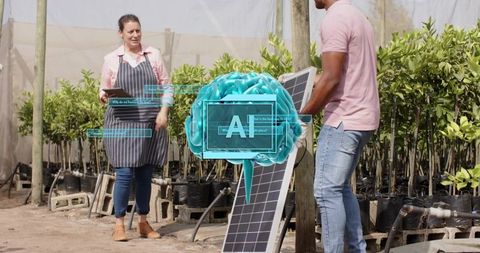 Technician installing solar panel while manager checking tablet in plant nursery