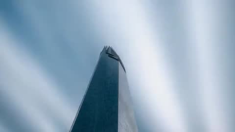 Filming Highrise Tower from Low Angle with Radial Cloud Timelapse and Glass Crown