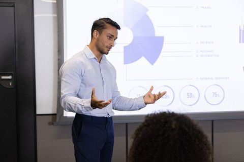 Professional Business Leader Presenting Data Insights in Modern Conference Room