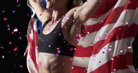 Victorious female athlete celebrates with usa flag and confetti
