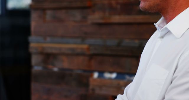 Professional in White Shirt with Wooden Background - Download Free Stock Photos Pikwizard.com