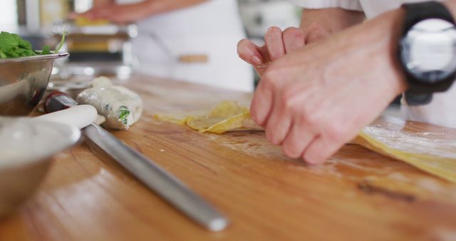 Close-Up of Hands Preparing Fresh Pasta on Wooden Counter in Kitchen - Download Free Stock Images Pikwizard.com