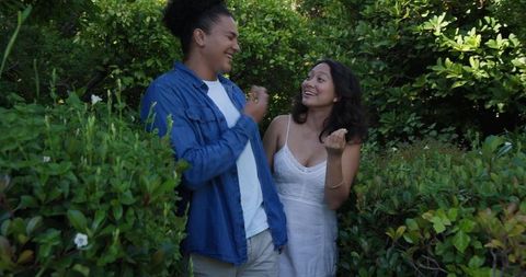Happy Couple Laughing in Lush Garden Outdoors
