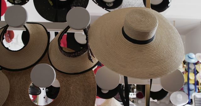 Stylish straw hats displayed in a chic boutique. Ideal for representing fashion stores, summerstyle, headwear collections, and upscale shopping environments.