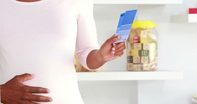 Pregnant Woman Choosing Color Swatches for Nursery Painting - Download Free Stock Images Pikwizard.com