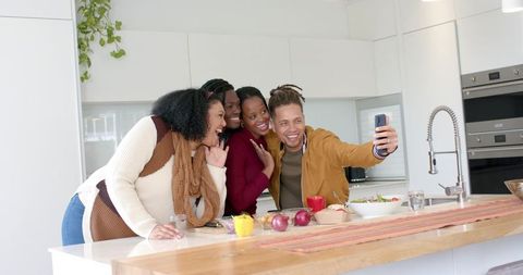Friends Taking Selfie at Modern Kitchen Island Laughing While Preparing Healthy Meal